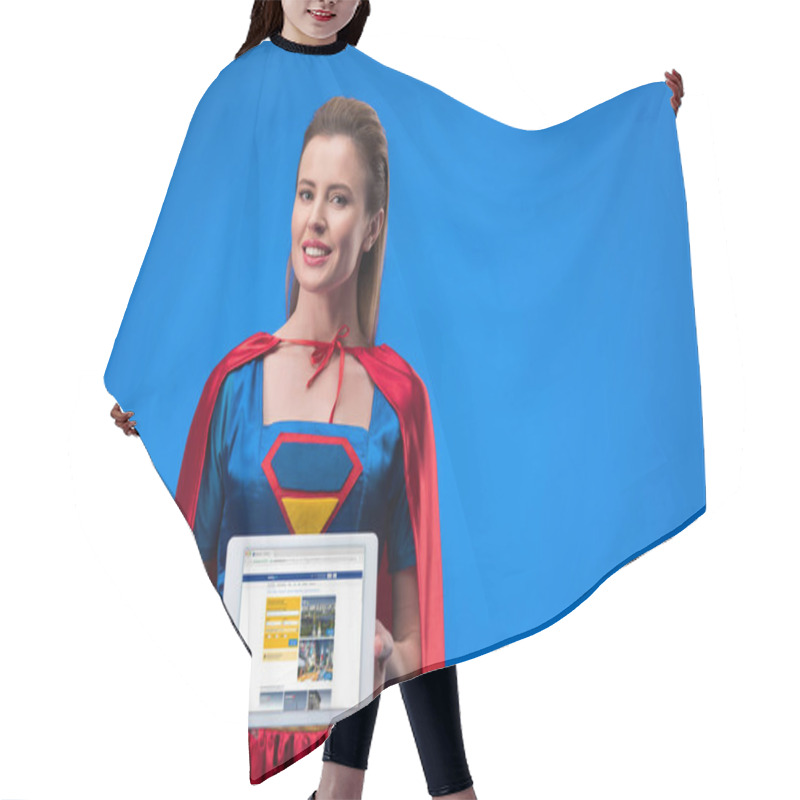 Personality  Portrait Of Smiling Woman In Superhero Costume Showing Tablet Isolated On Blue Hair Cutting Cape