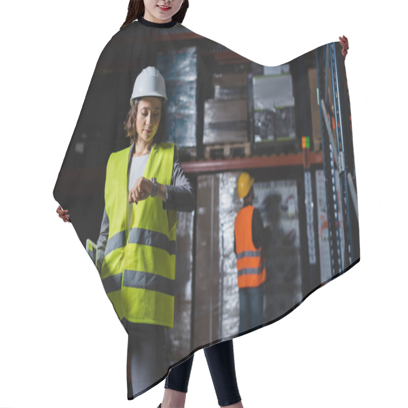 Personality  Female Warehouse Employee Checking Time On Wristwatch With A Male Colleague On Blurred Background Hair Cutting Cape