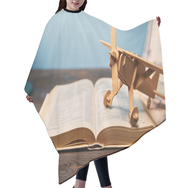 Personality  Selective Focus Of Book And Toy Plane On Wooden Table Hair Cutting Cape