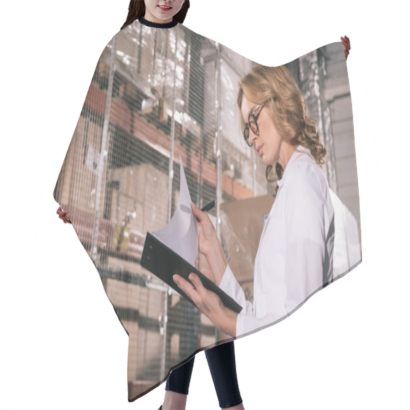 Personality  Concentrated Storekeeper Looking At Papers On Clipboard In Warehouse Hair Cutting Cape