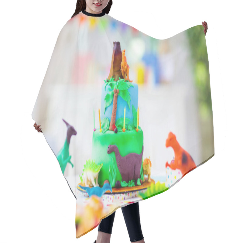 Personality  Kids Birthday Party. Dinosaur Theme Cake. Little Girl Blowing Candles And Opening Gifts. Children Event. Decoration For Dinosaurs Themed Celebration. Hair Cutting Cape