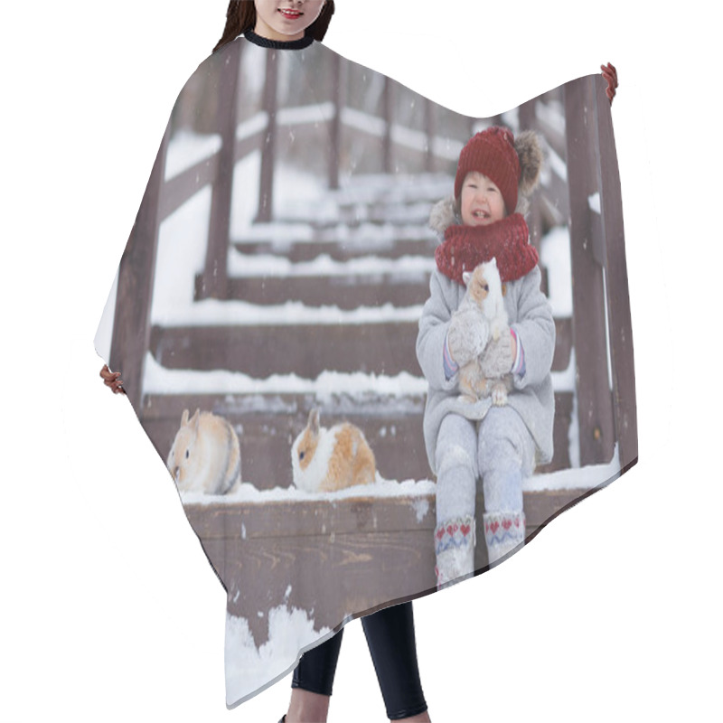 Personality  Little Girl Sitting On The Steps On Wooden Bridge With Rabbits In The Park At Winter  Hair Cutting Cape