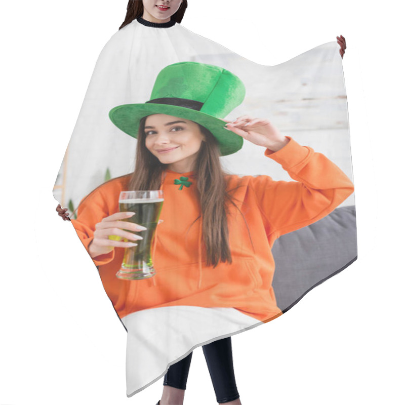 Personality  Positive Young Woman In Green Hat Holding Beer While Sitting On Couch  Hair Cutting Cape