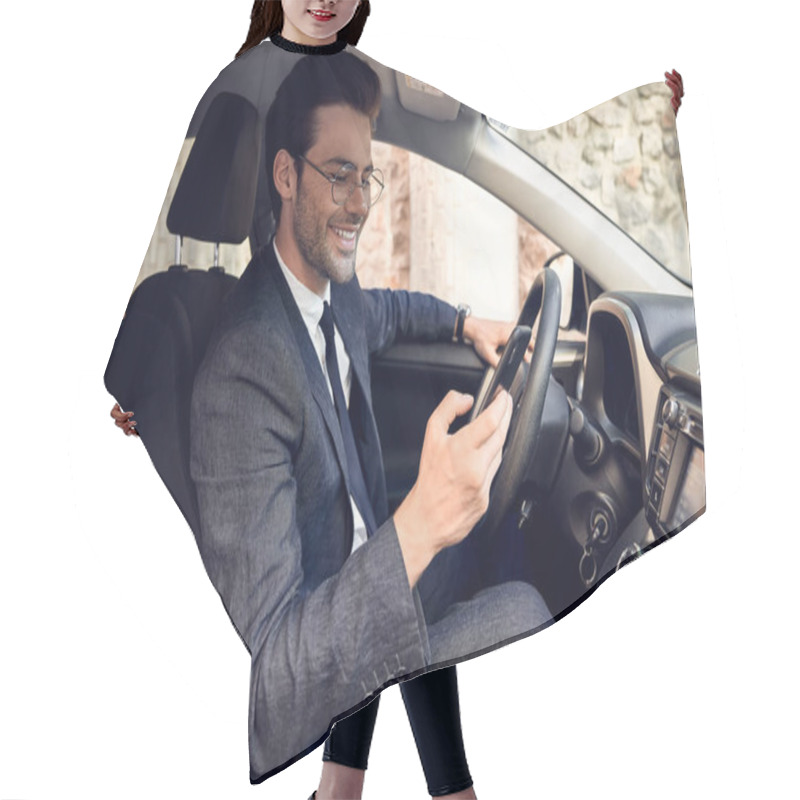 Personality  Side View Of Serious Business Man In Suit Using Phone While Sitting At The Wheel In Car. Hair Cutting Cape