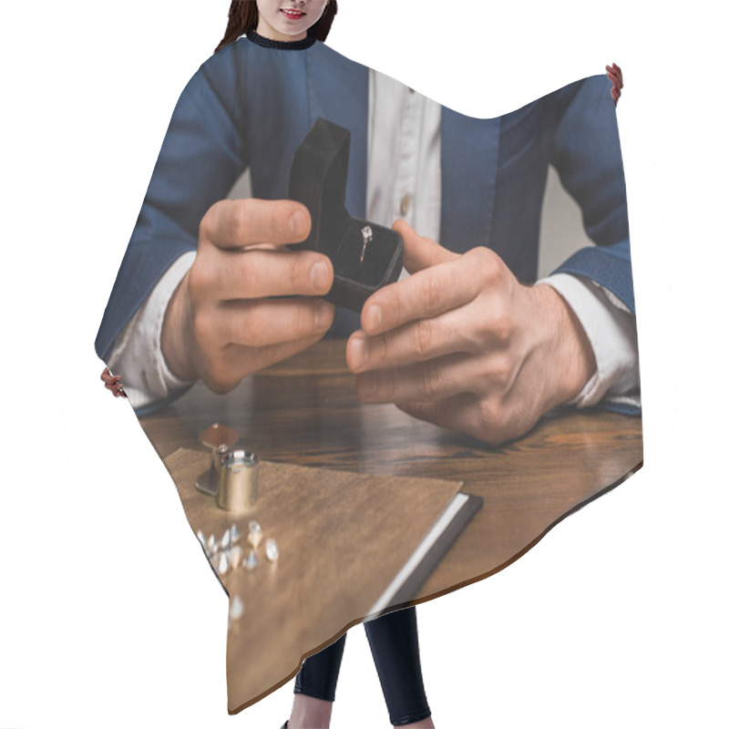 Personality  Cropped View Of Jewelry Appraiser Holding Box With Jewelry Ring Near Gemstones On Table On Grey Background Hair Cutting Cape