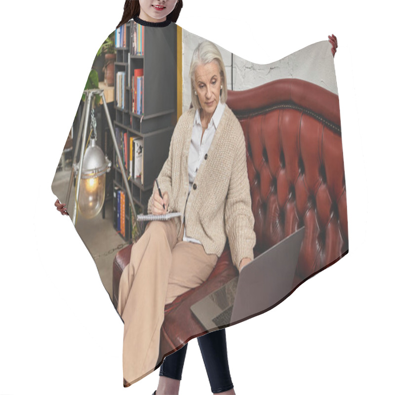 Personality  A Mature Woman With Lovely Gray Hair Relaxes In Her Cozy Living Room, Using Her Laptop. Hair Cutting Cape