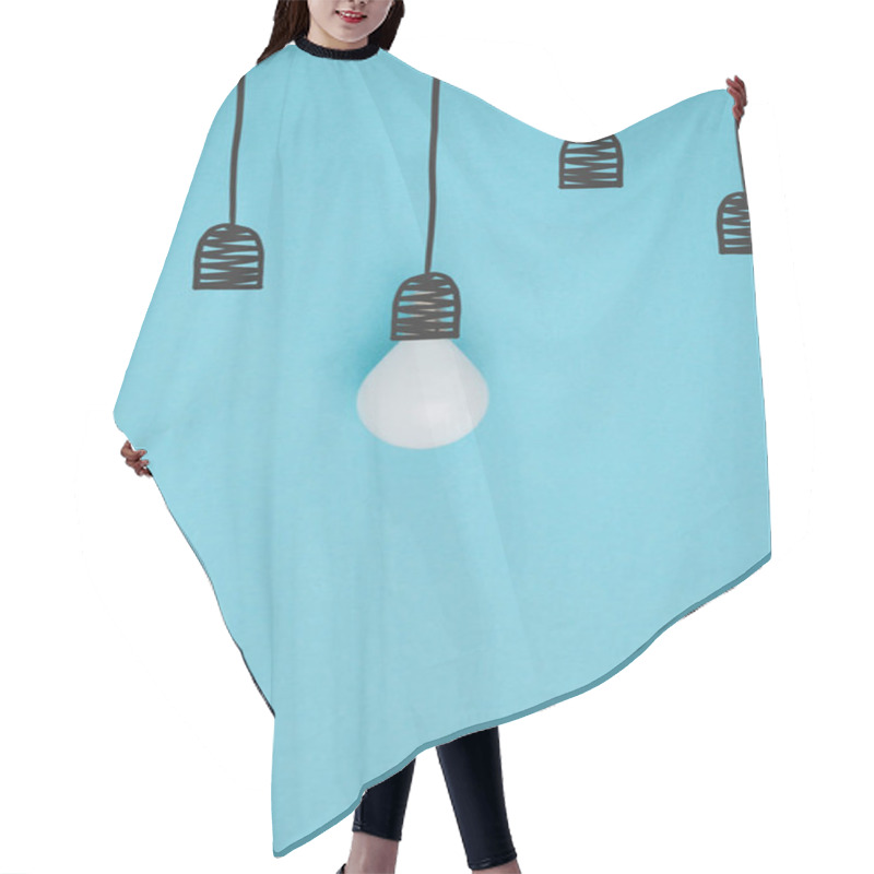 Personality  Top View Of Light Bulb Pretending Hanging On Lamp Holder Isolated On Blue Hair Cutting Cape