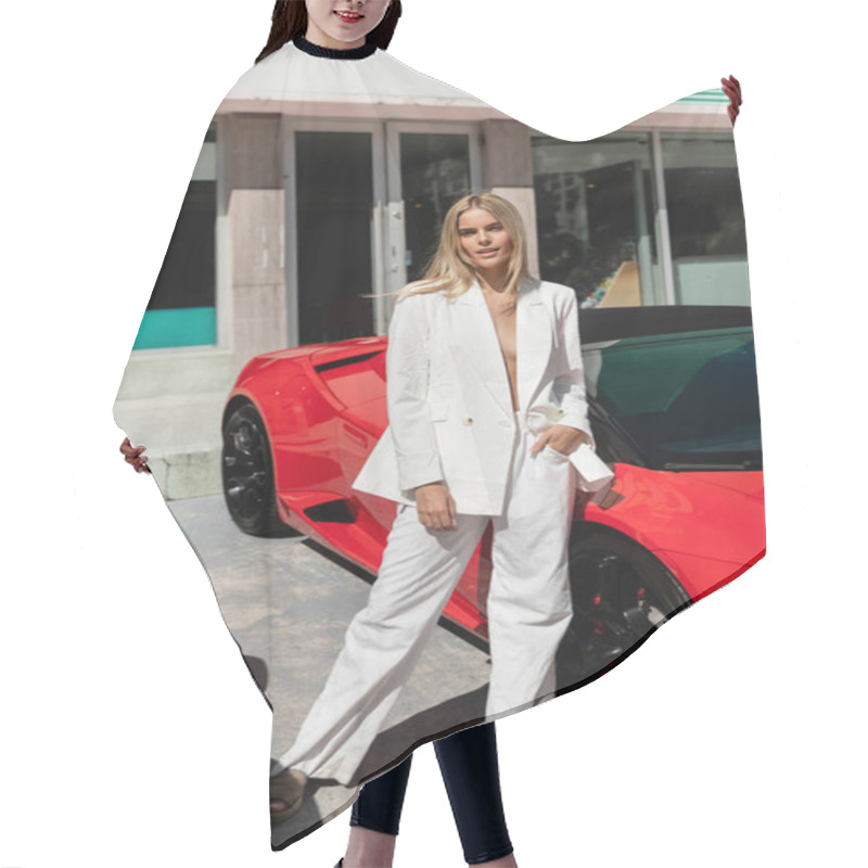 Personality  A Young, Beautiful Blonde Woman Standing Confidently Next To A Sleek Red Sports Car In Miami. Hair Cutting Cape