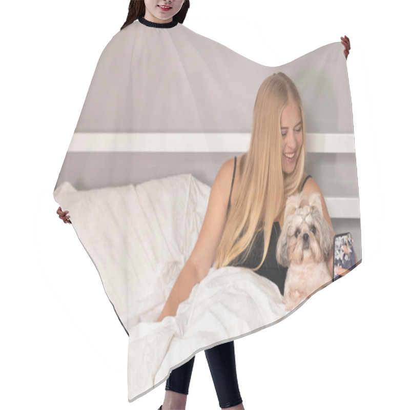 Personality  Beautiful Blonde With A Puppy Shih-tzu And A Phone On Bed With White Sheets. Pretty People And Pets On Isolation Hair Cutting Cape