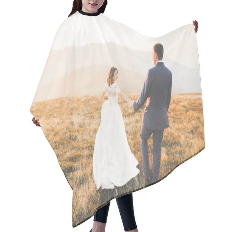 Personality  Wedding Couple Posing On Sunset At Wedding Day. Bride And Groom In Love Hair Cutting Cape