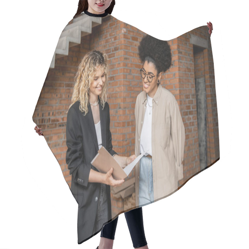 Personality  Smiling Real Estate Agent Showing Documents To African American Client In New House Hair Cutting Cape