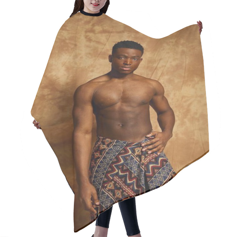 Personality  A Young Confident Man Stands Shirtless, Showcasing His Toned Physique. He Wears A Patterned Wrap That Adds A Cultural Touch. The Warm Toned Backdrop Enhances The Artistic Vibe Of The Moment. Hair Cutting Cape