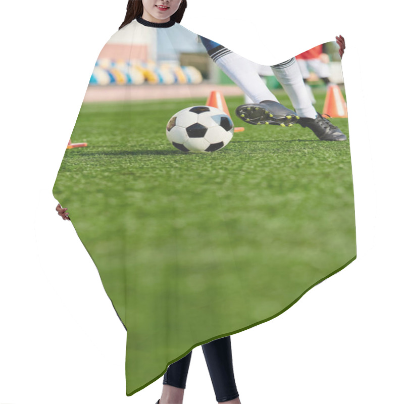 Personality  A Person Wearing Athletic Gear Is Kicking A Soccer Ball On A Green Field Under A Clear Blue Sky On A Sunny Day. Hair Cutting Cape