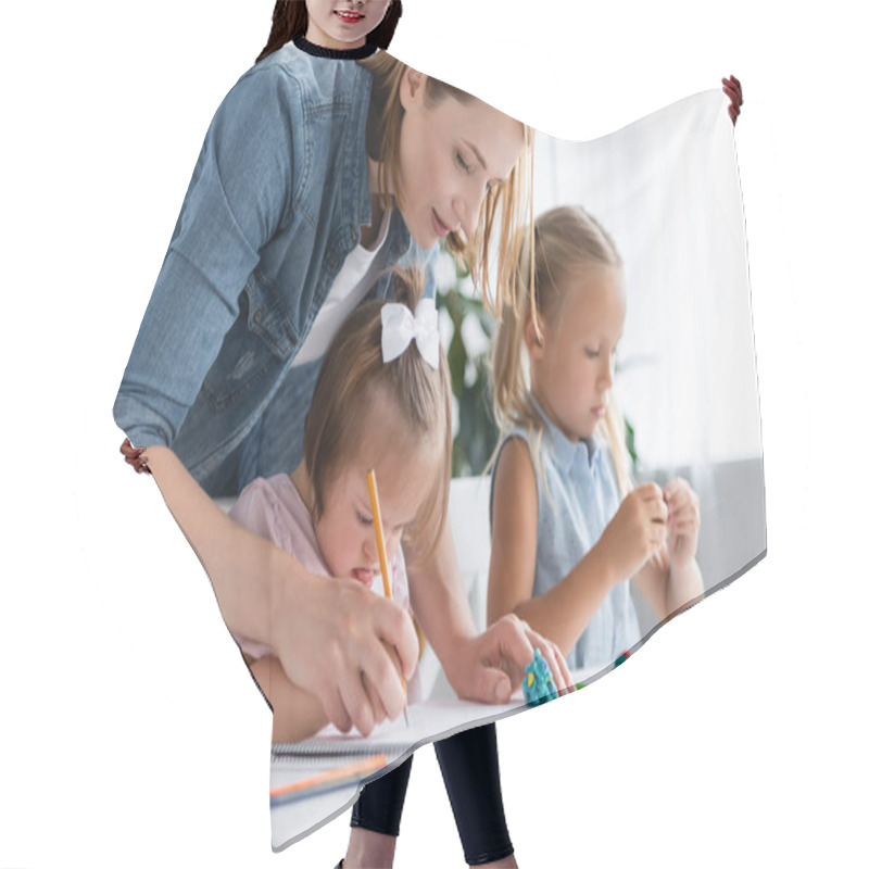 Personality  Teacher Assisting Disabled Child With Down Syndrome Drawing Near Blurred Child In Private Kindergarten  Hair Cutting Cape