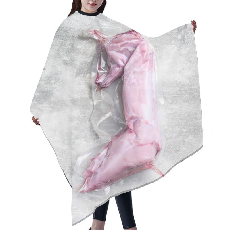 Personality  A Whole Raw Rabbit In A Vacuum Package. Gray Background. Top View. Hair Cutting Cape