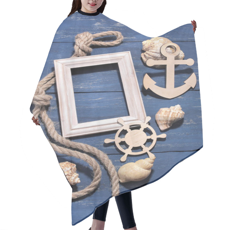 Personality  Marine Attributes. Rope, Frame, Wooden Anchor And Steering Wheel On A Blue Wooden Background. Top View Hair Cutting Cape