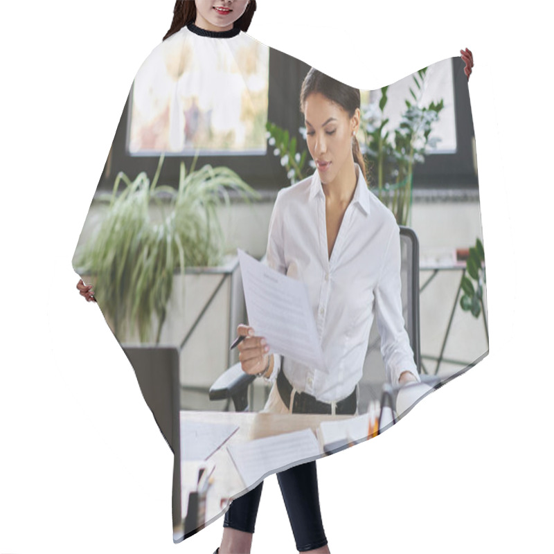 Personality  In A Bright Office, A Young African American Woman Is Examining Papers While Seated At Her Desk. Hair Cutting Cape