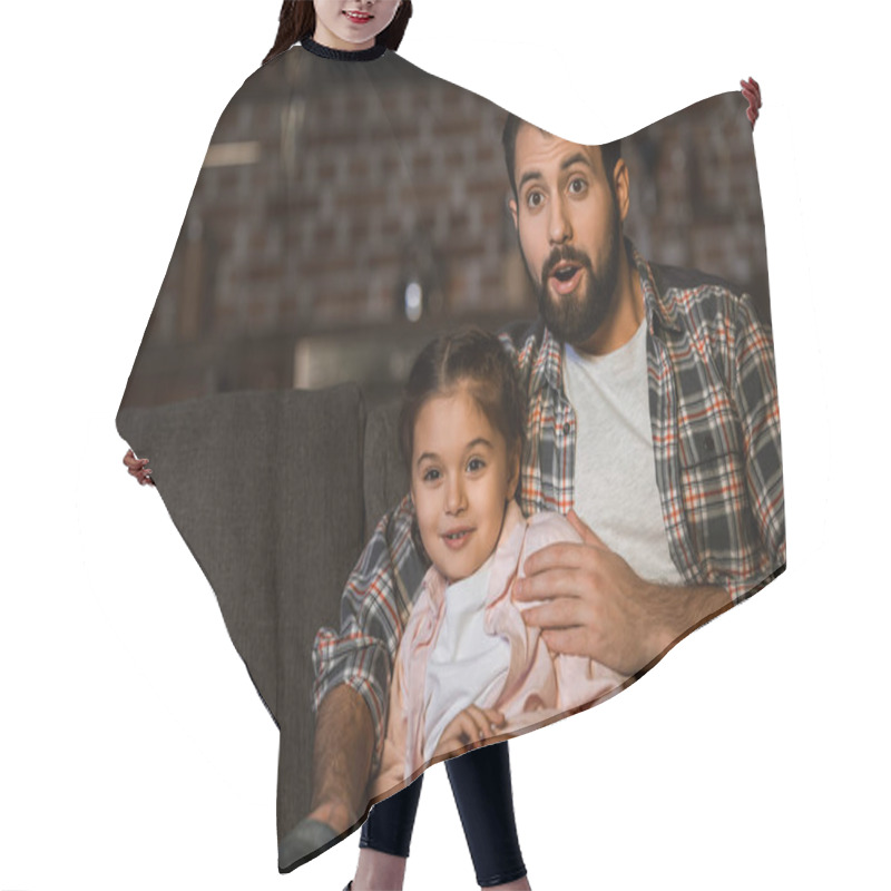 Personality  Surprised Father And Daughter Sitting On Couch And Watching Tv At Home Hair Cutting Cape