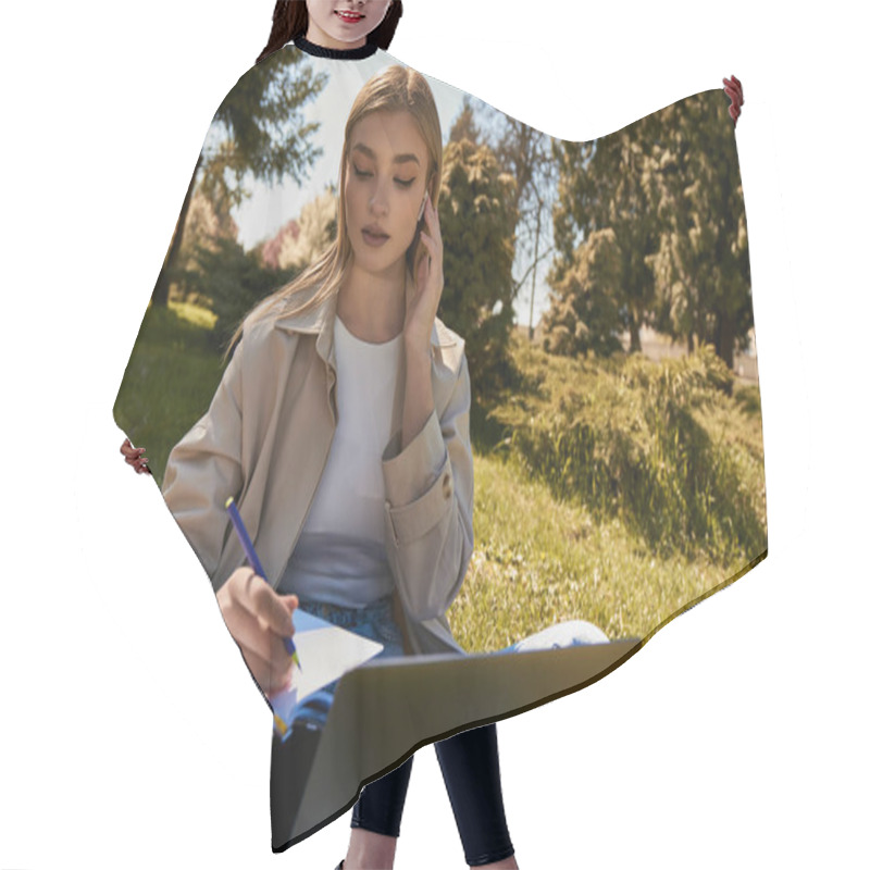 Personality  Blonde Woman In Trench Coat Writing In Notebook While Using Laptop And Sitting On Lawn In Park Hair Cutting Cape