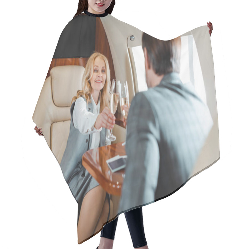 Personality  Selective Focus Of Smiling Businesswoman Toasting Champagne With Businessman In Airplane  Hair Cutting Cape