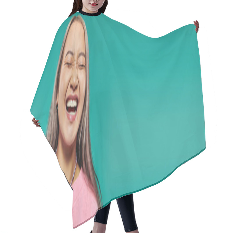 Personality  Portrait Of Cheerful And Young Asian Girl In Pink Sweatshirt Posing On Turquoise Background, Banner Hair Cutting Cape