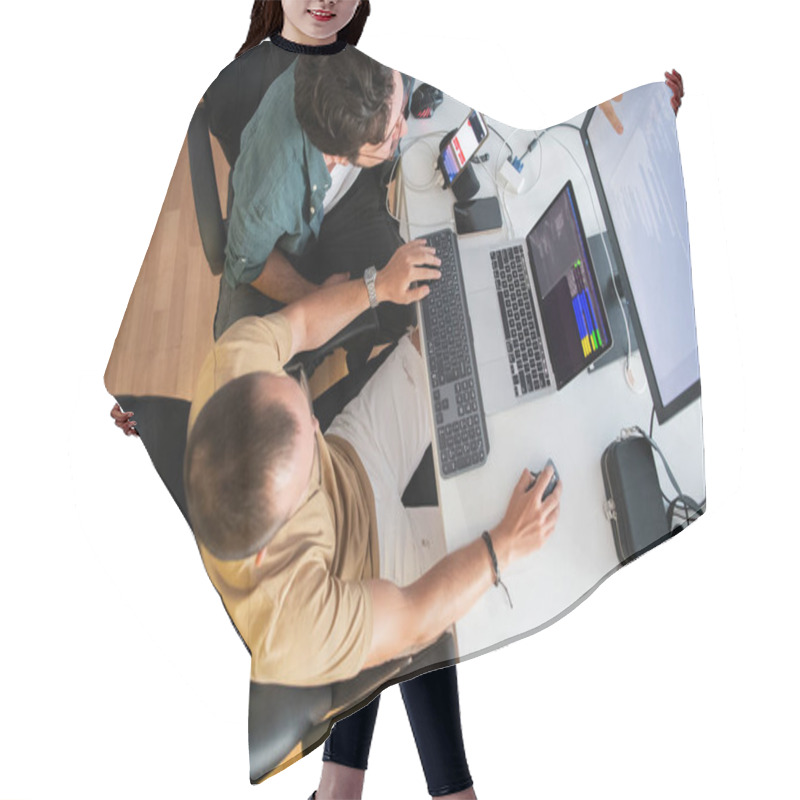 Personality  Top View Of Programmer Diligently Testing Smartphone Applications While Sitting In Their Office Hair Cutting Cape