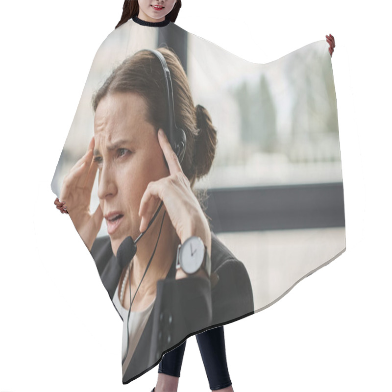 Personality  Middle-aged Woman Holding Head In Distress While Wearing A Headset. Hair Cutting Cape