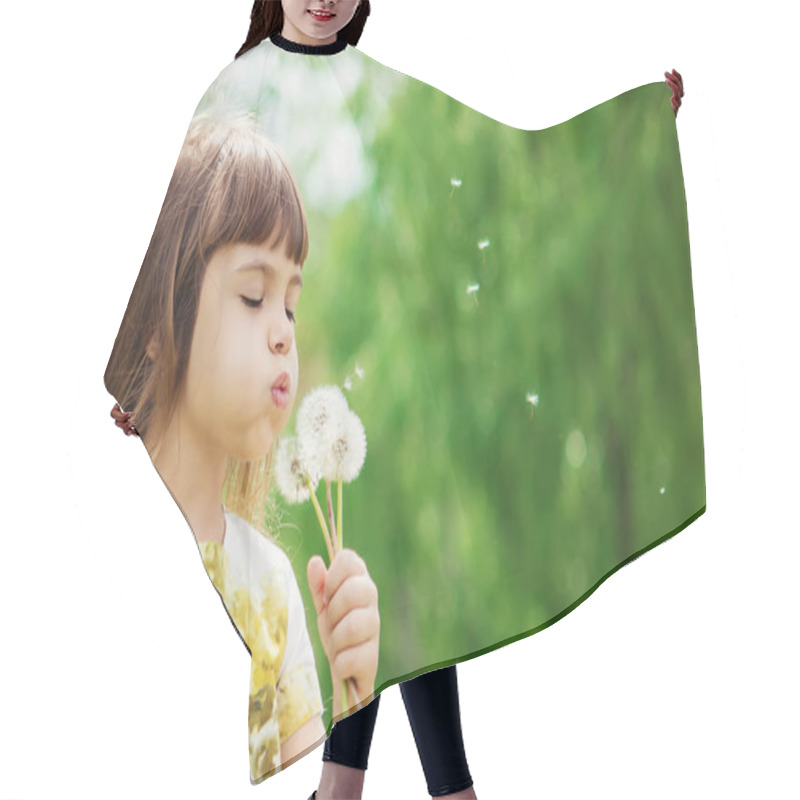 Personality  Girl Blowing Dandelions In The Air. Selective Focus. Hair Cutting Cape