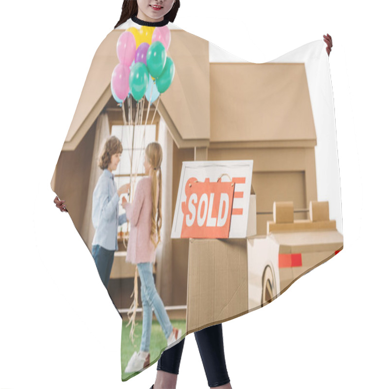 Personality  Kid Presenting Balloons To Girlfriend In Front Of Cardboard House With Sold Signboard On Foreground Isolated On White Hair Cutting Cape