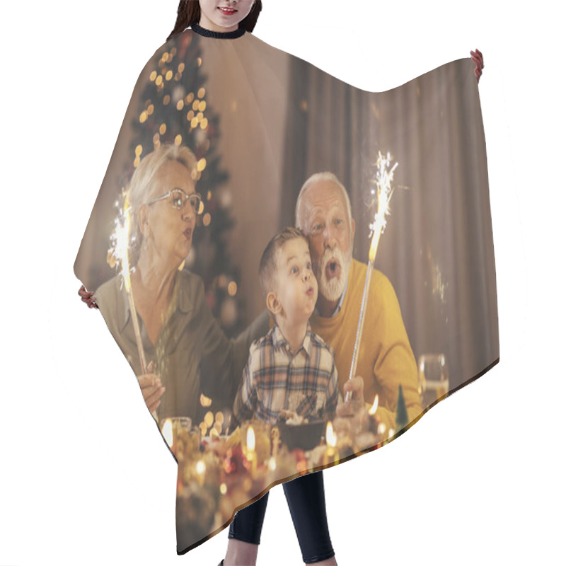 Personality  Senior Couple Is Having Fun With Grandchild Celebrating Christmas And New Year's Eve With Fireworks At Table At Home. Hair Cutting Cape