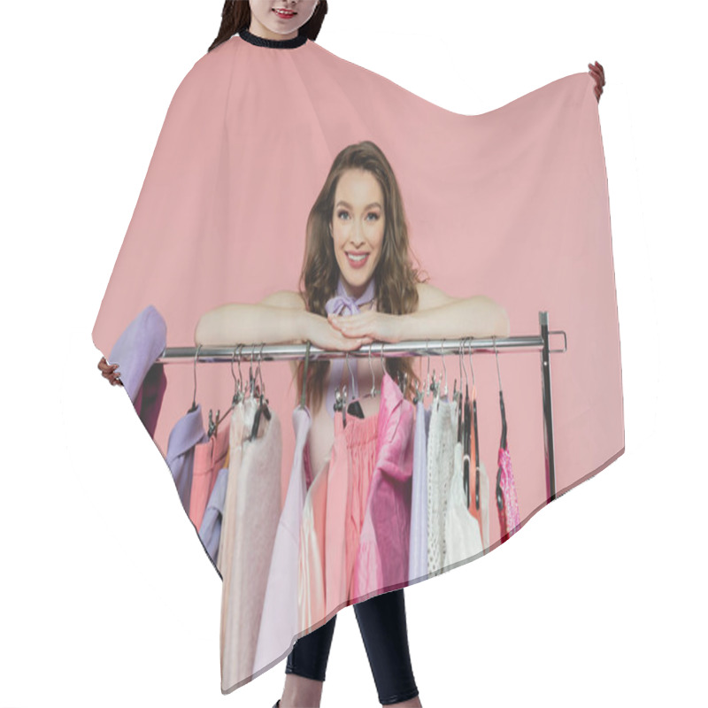 Personality  Consumerism, Cheerful Young Woman With Brunette Wavy Hair Standing Near Rack With Clothes, Wardrobe Selection Concept, Fashion And Trends, Beautiful Model Looking At Camera On Pink Background  Hair Cutting Cape