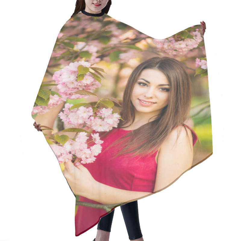 Personality  Portrait Of Beutiful Girl In Sakura Tree. Sakura Flowers Surround The Girl. Sakura Branch By Her Face. Japanese Tree Hair Cutting Cape