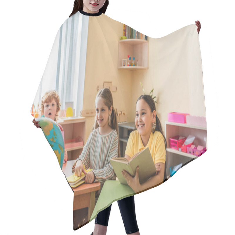 Personality  Happy Multiethnic Children Looking At Teacher Holding Globe In Classroom Hair Cutting Cape