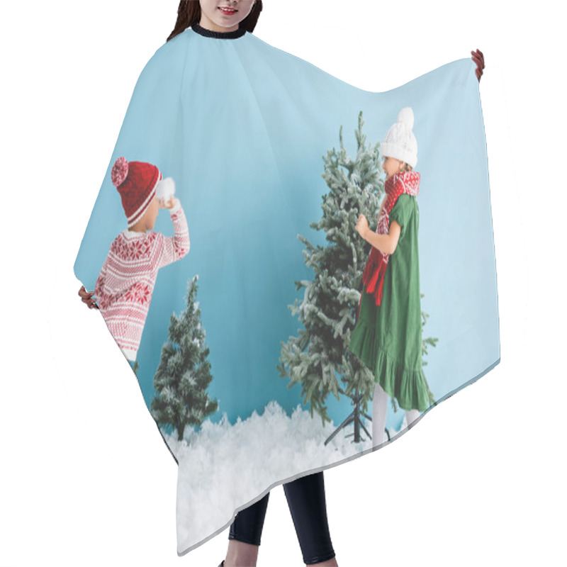 Personality  Kids In Winter Outfit Playing Snowballs Near Christmas Trees On Blue Hair Cutting Cape