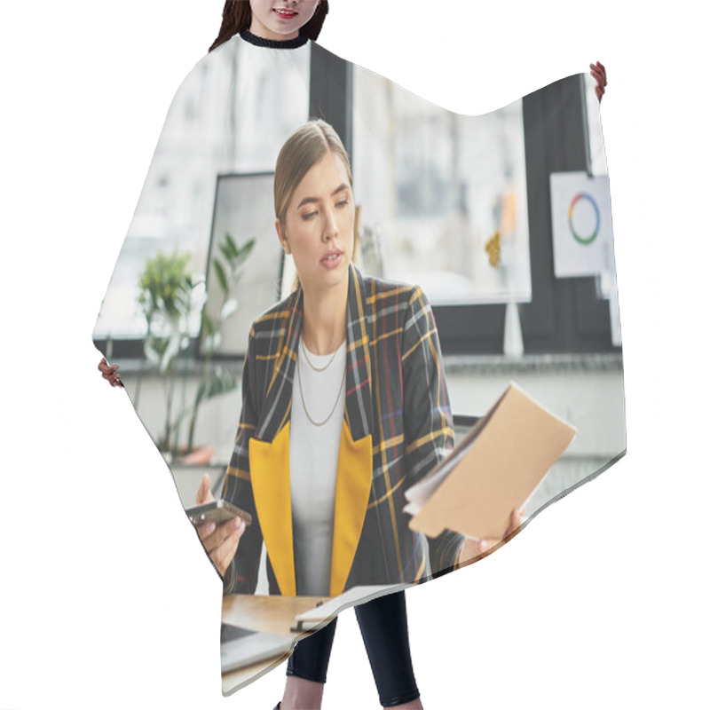 Personality  Focused Young Woman In Checkered Blazer Juggles Tasks While Working In A Bright Office Space. Hair Cutting Cape