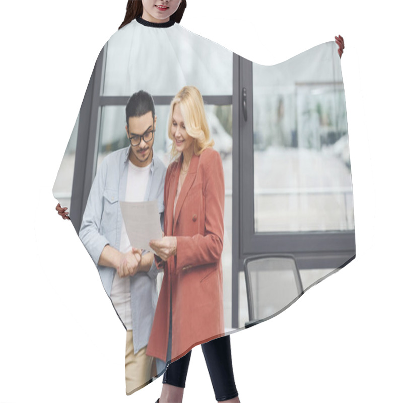 Personality  A Man And Woman Analyzing A Document In An Office. Hair Cutting Cape