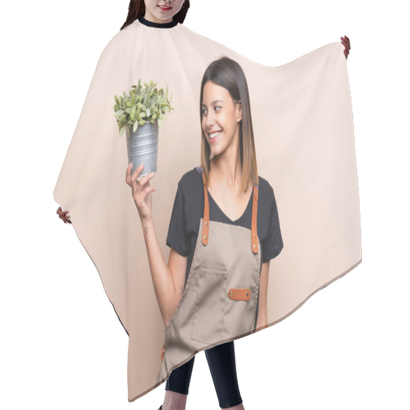 Personality  Young Woman Holding A Plant With Happy Expression Hair Cutting Cape