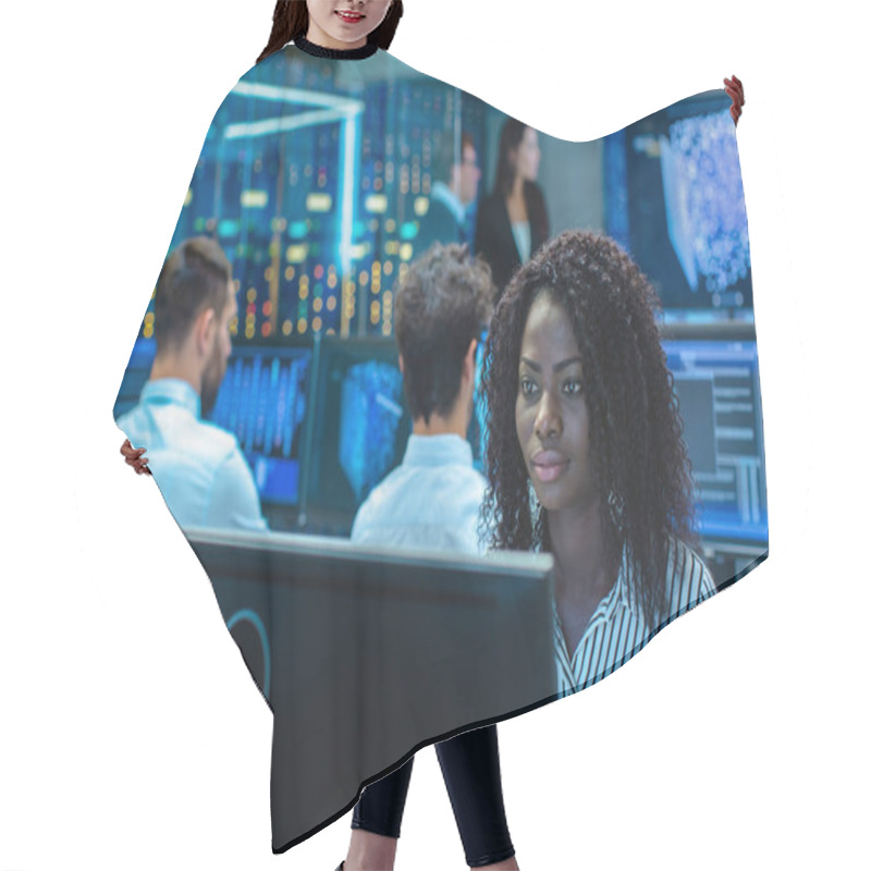 Personality  Female Computer Engineer Works On A Neural Network/ Artificial Intelligence Project With Her Multi-Ethnic Team Of Specialist. Office Has Multiple Screens Showing 3D Visualization. Hair Cutting Cape