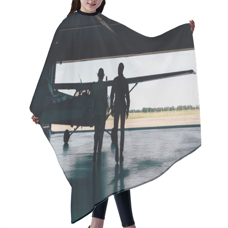 Personality  Rear View Of Silhouettes Of Stylish Couple Walking Near Airplane In Hangar  Hair Cutting Cape