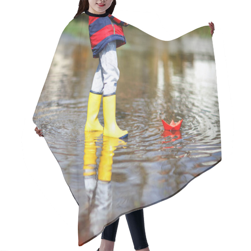 Personality  Happy Little Kid Boy In Yellow Rain Boots Playing With Paper Ship Boat By Huge Puddle On Spring Or Autumn Day. Active Leisure For Children. Funny Child Having Fun Outdoors, Wearing Colorful Clothes. Hair Cutting Cape