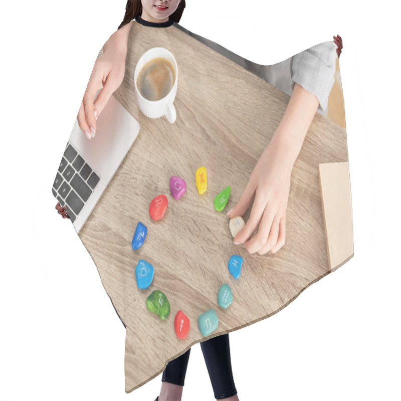 Personality  Top View Of Astrologer Using Stones With Zodiac Sign And Laptop Beside Coffee On Table, Cropped View Hair Cutting Cape