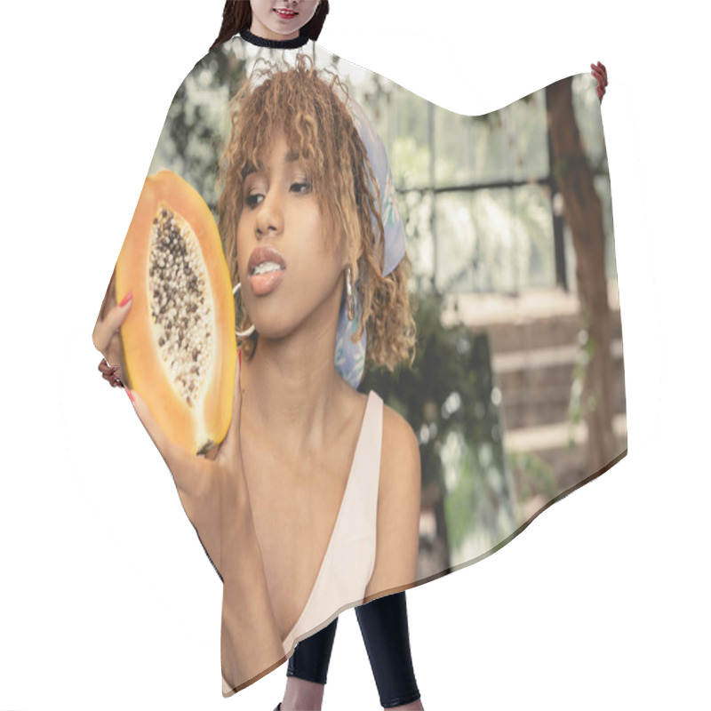 Personality  Portrait Of Fashionable Young African American Woman In Headscarf Holding Fresh Papaya While Spending Time In Blurred Garden Center, Stylish Lady Blending Fashion And Nature, Summer Concept Hair Cutting Cape