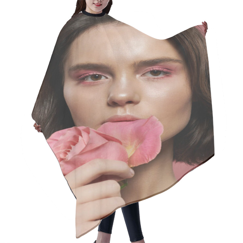 Personality  A Woman Holds A Single Pink Rose Against A Soft Pink Backdrop. Hair Cutting Cape