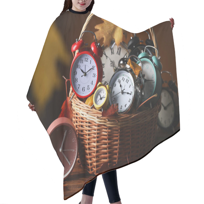 Personality  Alarm Clocks And Dry Leaves In Wicker Basket On Wooden Table Against Brown Background Hair Cutting Cape