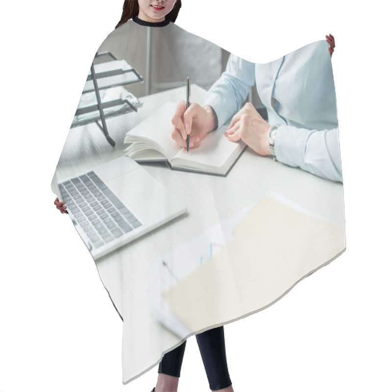 Personality  Cropped View Of Businesswoman Writing In Notebook, While Sitting At Workplace With Laptop On Blurred Foreground Hair Cutting Cape