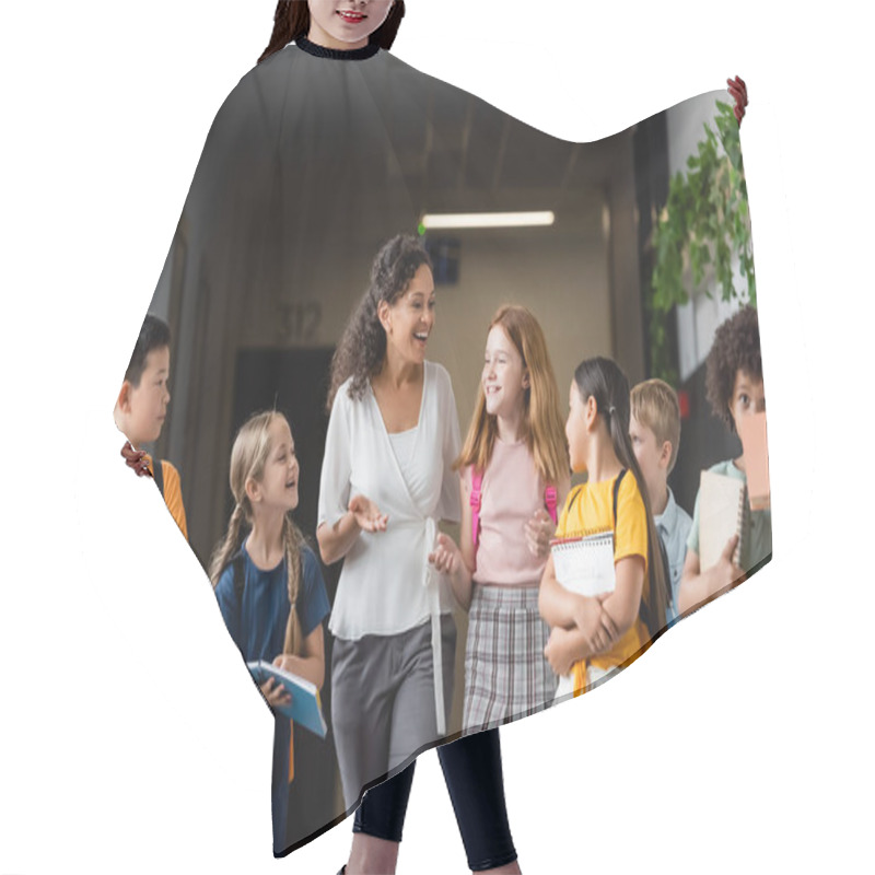 Personality  Positive African American Teacher Gesturing While Talking To Multicultural Pupils In School Hall Hair Cutting Cape