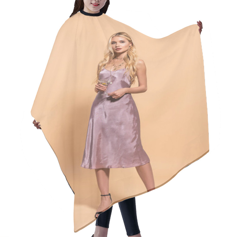 Personality  Elegant Blonde Woman In Violet Satin Dress And Necklace Holding Cocktail On Beige Hair Cutting Cape