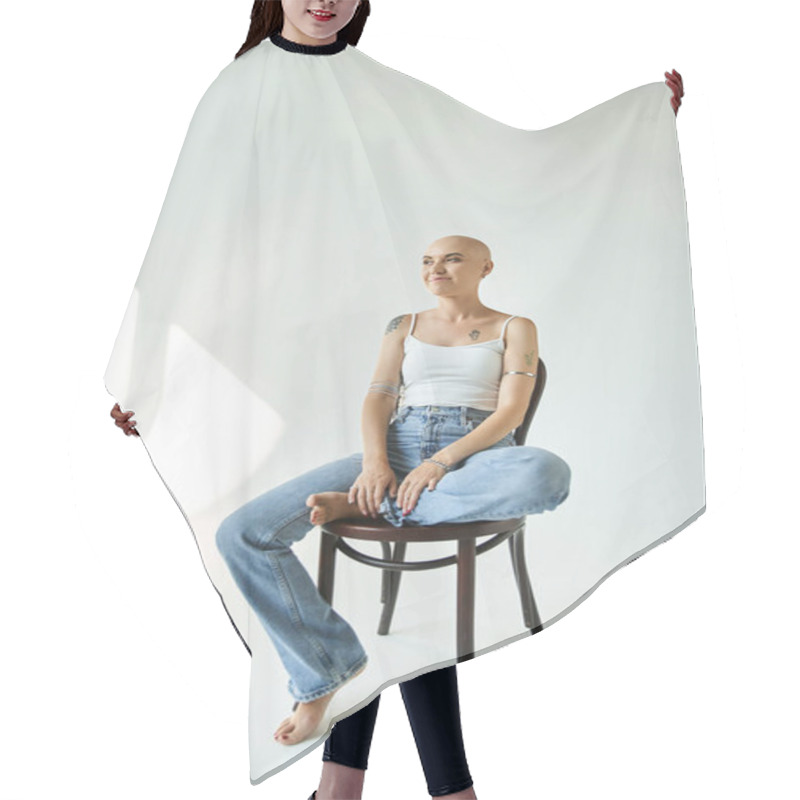 Personality  A Young Bald Woman Exudes Self Assurance As She Poses Gracefully In Soft Light. Hair Cutting Cape