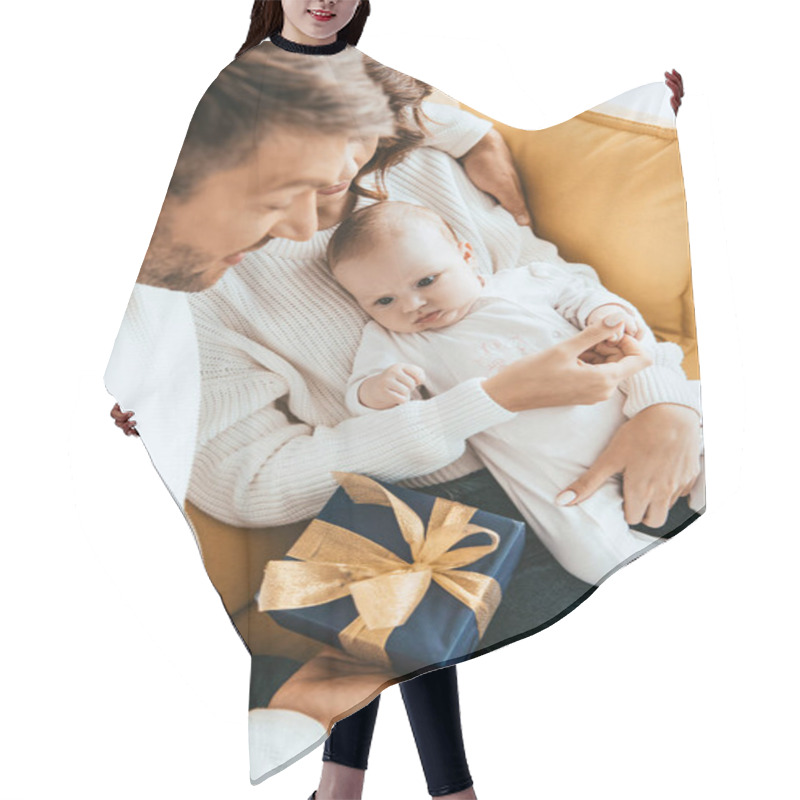 Personality  Father Presenting Gift Box To Adorable Little Daughter Sitting On Mothers Hands Hair Cutting Cape