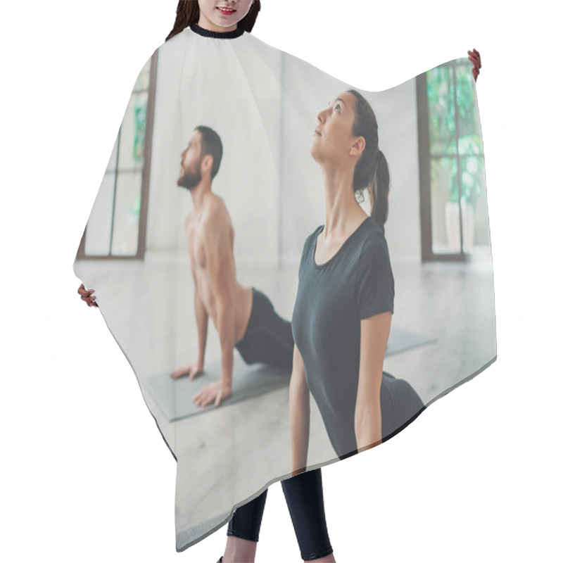 Personality  Young Sportive Man And Woman Are Practicing Yoga Exercises In The Studio. Couple Of Young Sporty People Practicing Yoga Lesson With Partner Hair Cutting Cape